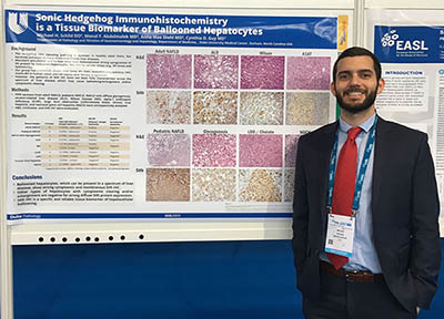 Resident with research poster