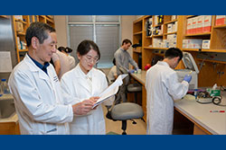 Dr. Huang, left, in his lab