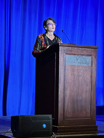 Andrea Deyrup, MD, PhD, speaking at podium