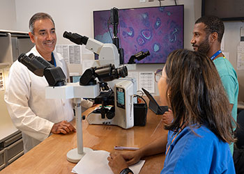 Rajesh Dash, MD (left) with residents Natalya Ramirez, MD (front) and Jarvis Williams, MD (back)