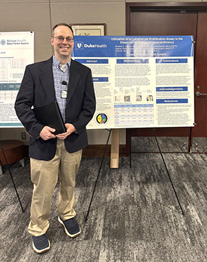 Dr. Bradley Carson in front of his poster