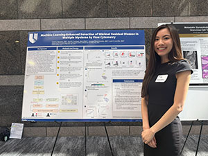 Dr. Tran Nguyen in front of her poster