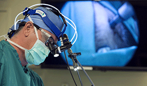 Dr. John Sampson operating in 2019