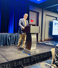 Dr. Gary Procop giving lecture at podium