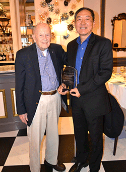 Dr. Jiaoti Huang (right) presents Dr. Bill Bradford with award