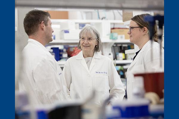 Dr. Virginia Byers Kraus speaking with colleagues