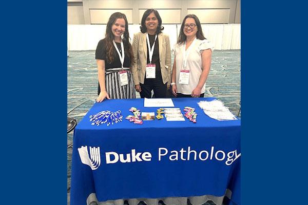 Left to right: Dr. Abigail Hitt, Dr. Avani Pendse, Dr. Jadee Neff at table representing Duke