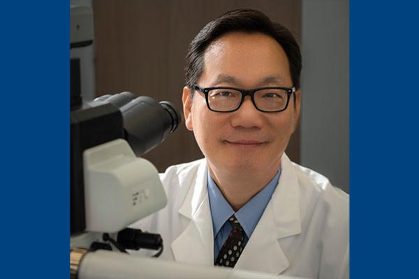 Ken H. Young, MD, PhD, at microscope