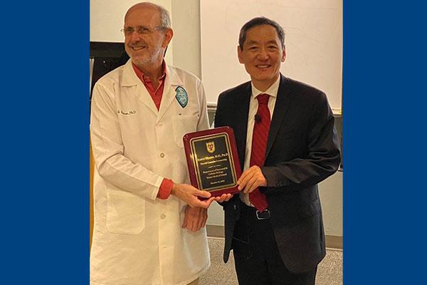 Brian G. Rowan, PhD, Chair, Department of Structural & Cellular Biology at Tulane University, and Jiaoti Huang, MD, PhD