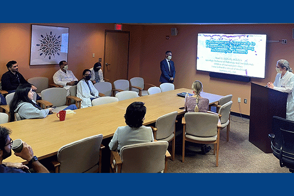 Rami Al-Rohil, MBBS, presenting at Albany Medical Center to a group