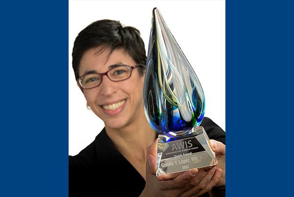 Dr. Giselle Lopez holding her award