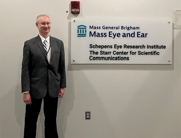 Dr. Thomas J. Cummings in front of Mass Eye and Ear sign