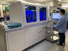 Duke clinician in lab by machine