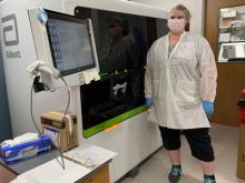 Duke clinician in lab by machine