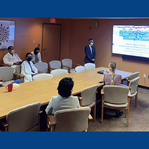 Rami Al-Rohil, MBBS, presenting at Albany Medical Center to a group